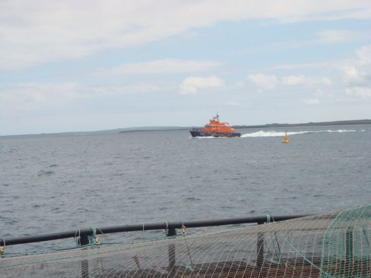 Kirkwall lifeboat going past Puldrite salmon cages