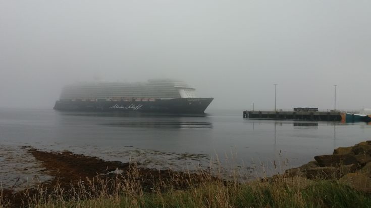 Mein Schiff 3 emerges from the fog.